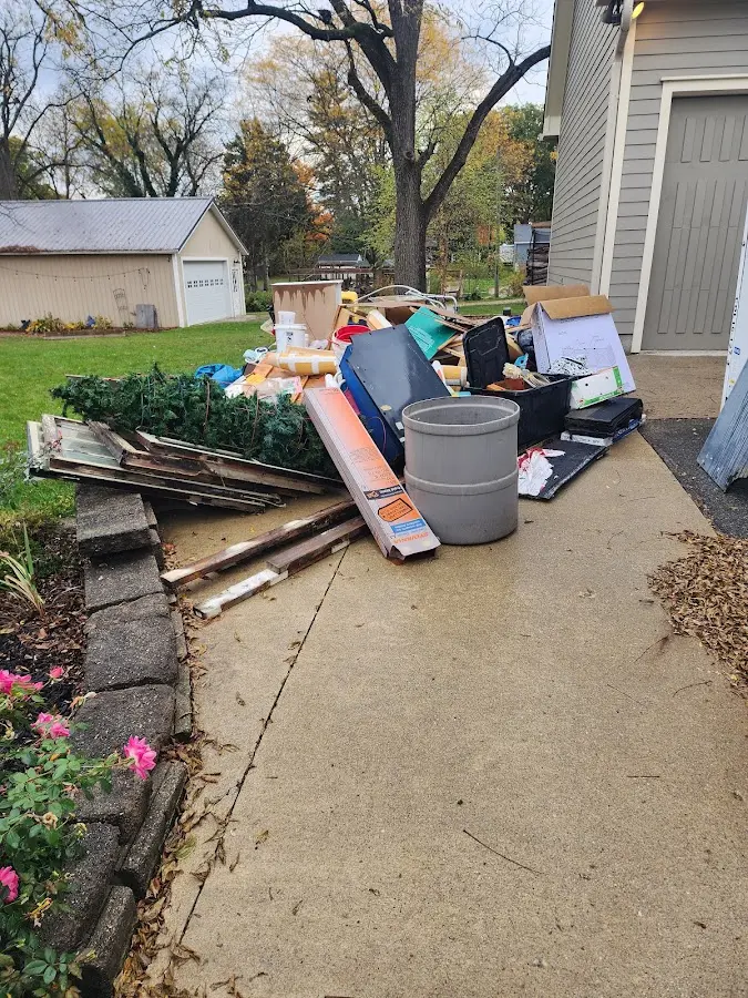 Dumpster being loaded with debris for Estate Cleanout Dumpster Rental in Spring